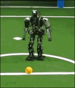 Robot attempts to kick ball, moves it slightly, swings and misses and then falls over.